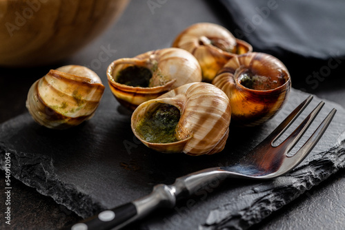 Snails with parsley butter, Bourgogne Escargot Snails on cutting board. Delikatese food. photo