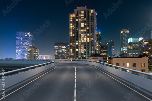 Empty urban asphalt road exterior with city buildings background. New modern highway concrete construction. Concept of way to success. Transportation logistic industry fast delivery. Los Angeles. USA. © VideoFlow
