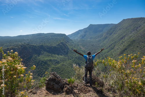 Rear view of a hiker against the background of the volcanic crater on Mount Suswa in Kenya photo