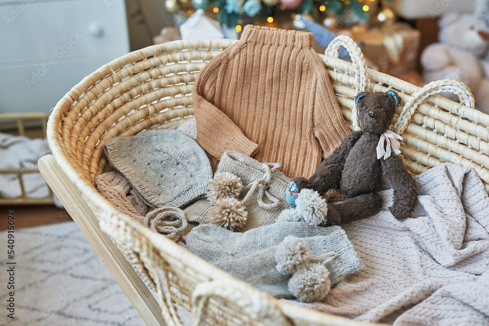 Obraz premium Baby knitted clothes and accessories. Baby shower party. Christening dress. Handmade knitting. Christmas background