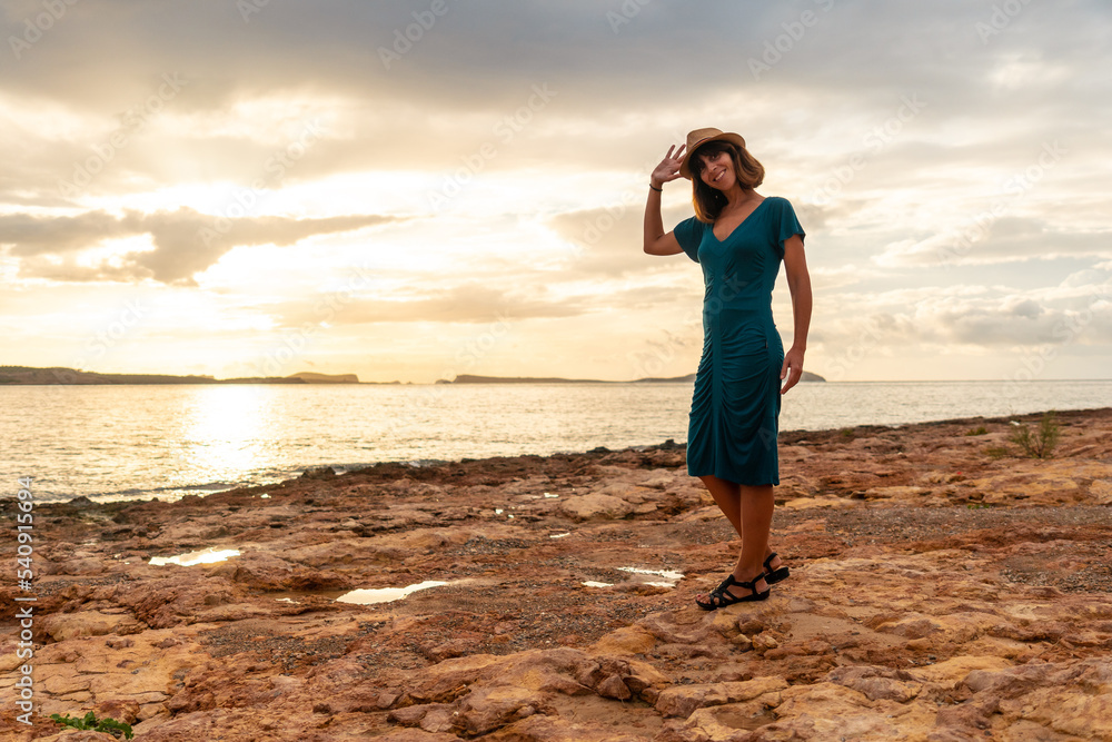 A young tourist at sunset on the Paseo de Poniente in San Antonio Abad, Ibiza Island. Balearic