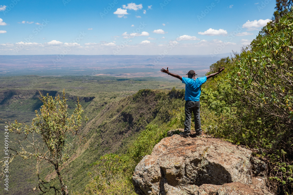 Rear view of a hiker against the background of the volcanic crater on Mount Suswa in Kenya