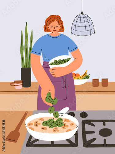 Woman cooking dinner at home kitchen. Young girl stewing mushrooms in cream o...