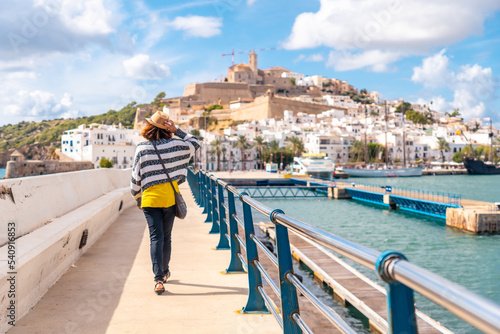 A young woman visiting coastal Ibiza town on winter vacation from Al Faro, Balearic Islands