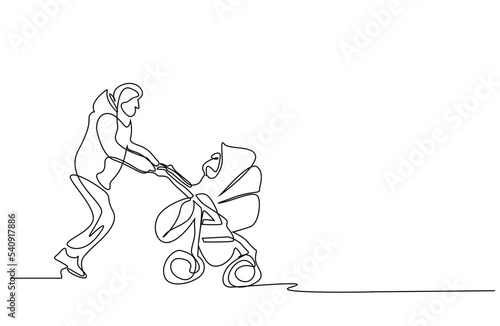 father walks his child with baby carriage outside in winter
