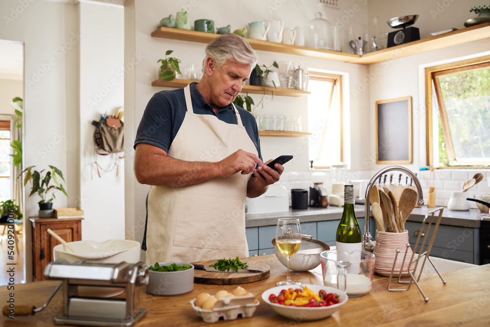 Senior man, retirement and cooking in kitchen, smartphone and search internet for food recipe, technology and online connection. Healthy diet, chef skill development and research meal ideas. Senior man, retirement and cooking in kitchen, smartphone and search internet for food recipe, technology and online connection. Healthy diet, chef skill development and research meal ideas.