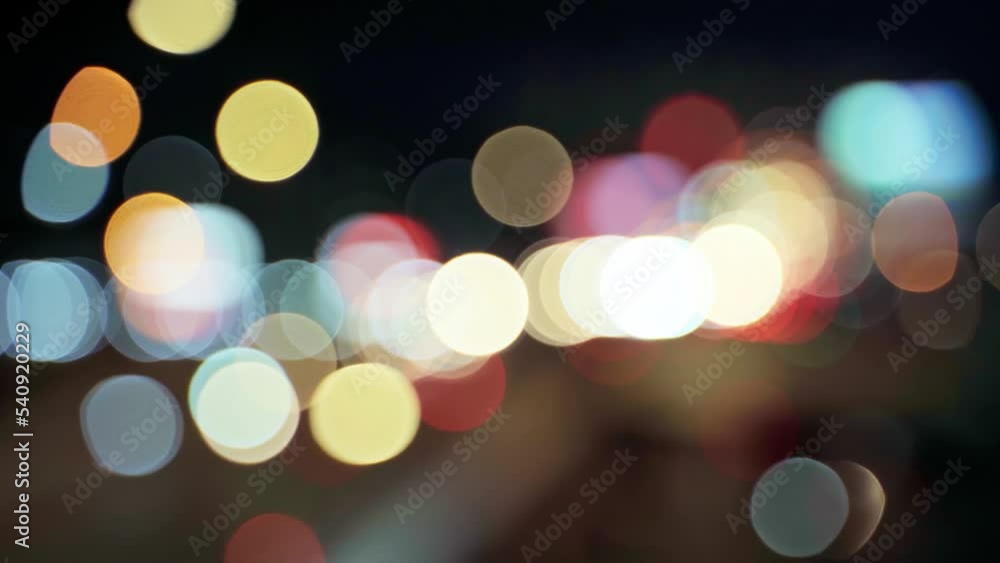 Night road lights blurred bokeh of cars in traffic on the road at night. Abstract bright blurred colored bokeh. Bokeh traffic lights in the city night background Night road lights blurred bokeh of cars in traffic on the road at night. Abstract bright blurred colored bokeh. Bokeh traffic lights in the city night background