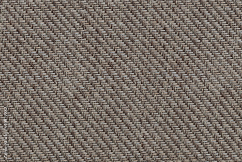 Texture of beige fabric of large herringbone weave