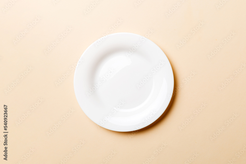 Top view of isolated of colored background empty round white plate for food. Empty dish with space for your design Top view of isolated of colored background empty round white plate for food. Empty dish with space for your design