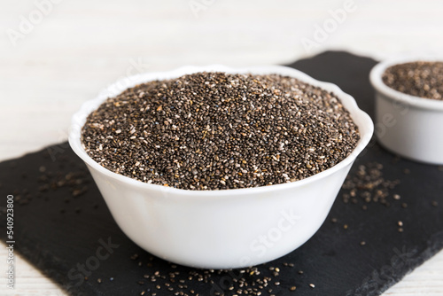 Chia seeds in bowl on colored background. Healthy Salvia hispanica in small bowl. Healthy superfood