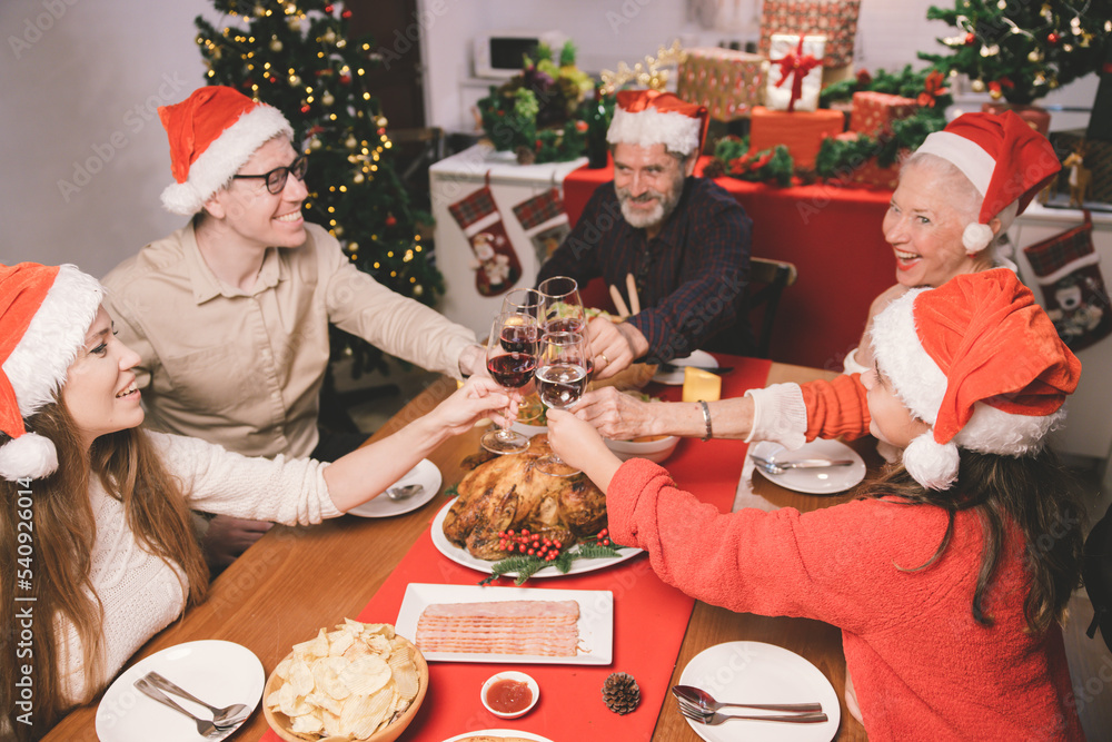 Merry Christmas! Happy family are having dinner at home. Celebration holiday and togetherness near tree Merry Christmas! Happy family are having dinner at home. Celebration holiday and togetherness near tree
