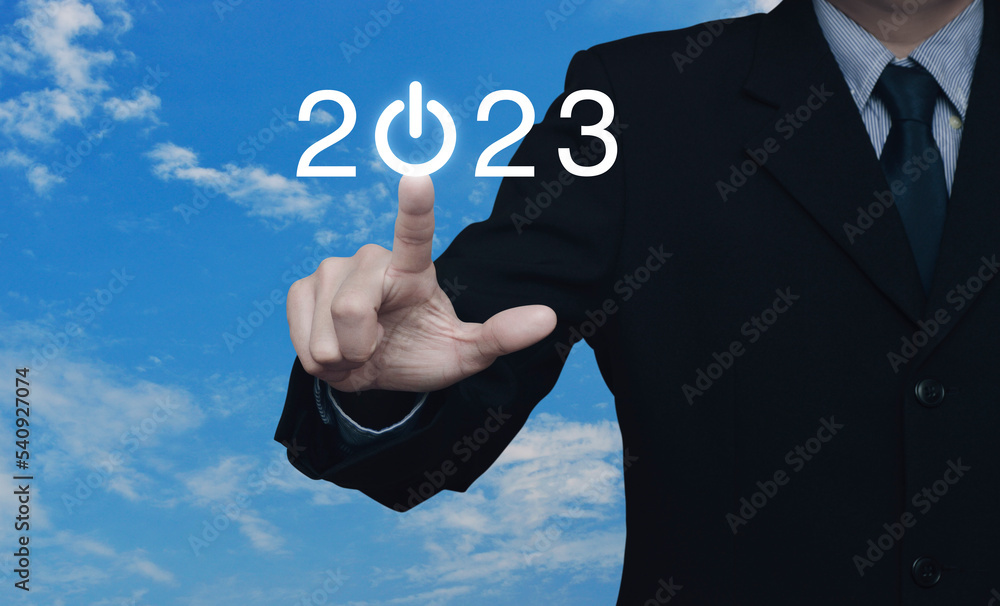 Businessman pressing 2023 start up business flat icon over blue sky with white clouds, Business happy new year 2023 cover concept Businessman pressing 2023 start up business flat icon over blue sky with white clouds, Business happy new year 2023 cover concept