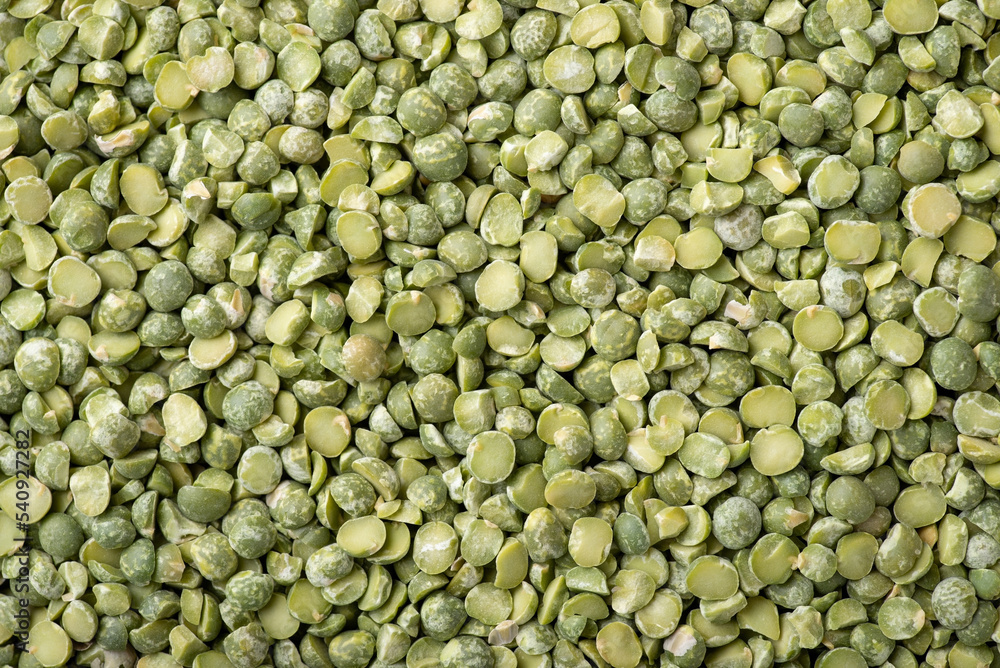 Background of green pea broken in half. Green dry pea, top-down shot. Cooking with pea Background of green pea broken in half. Green dry pea, top-down shot. Cooking with pea