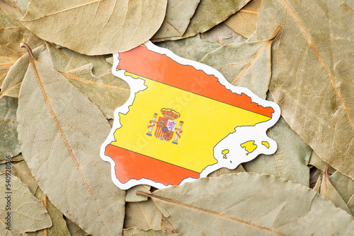 Flag and map of Spain on bay leaf. Origin, business of growing aromatic leaf in Spain © Vitalii
