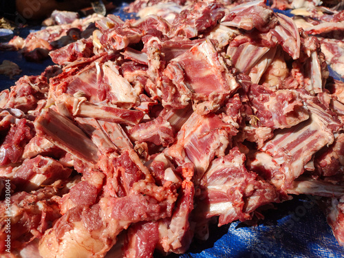 A bunch of fresh goat ribs placed on tarpaulin after cutting for Ied Adha celebration, shot at diagonal angle