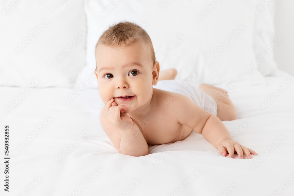 Cute baby lying on stomach with cute thinking expression Cute baby lying on stomach with cute thinking expression
