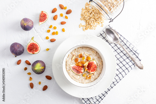 Breakfast with oatmeal porridge decorated with figs and bananas