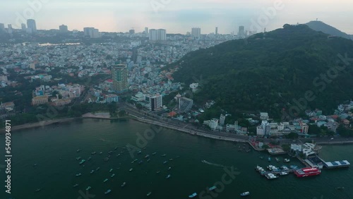 Vung Tau, Vietnam from high angle in early morning. This shows the established part of the city and landmarks. Aerial orbit and reveal shot photo