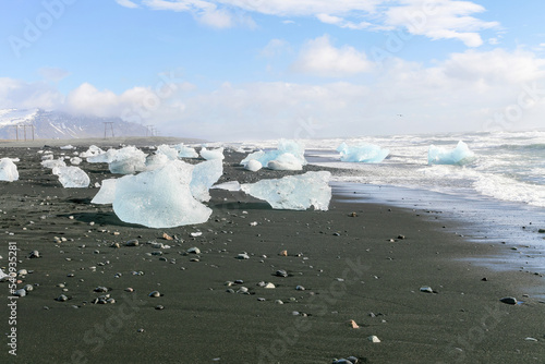 Big blocks of clear ice on the black beach