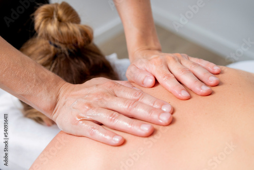 Young woman at the spa receiving a full body massage