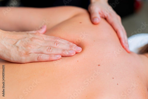 Young woman at the spa receiving a full body massage