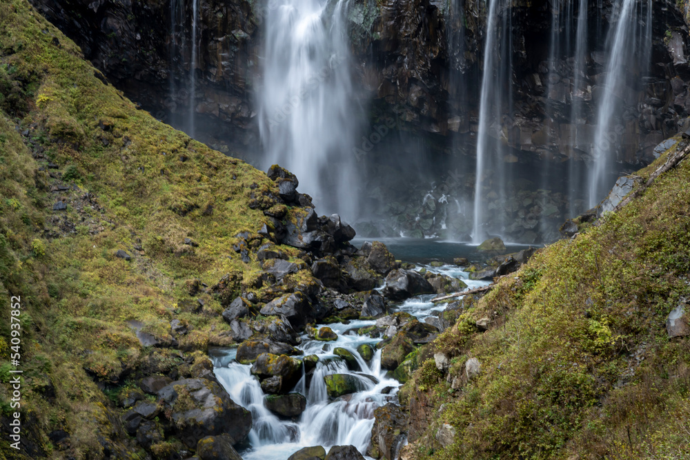 Obraz premium Colorful majestic waterfall in national park forest during autumn nature Photography.Landscape view national nature park Nikko Japan. Beautiful place