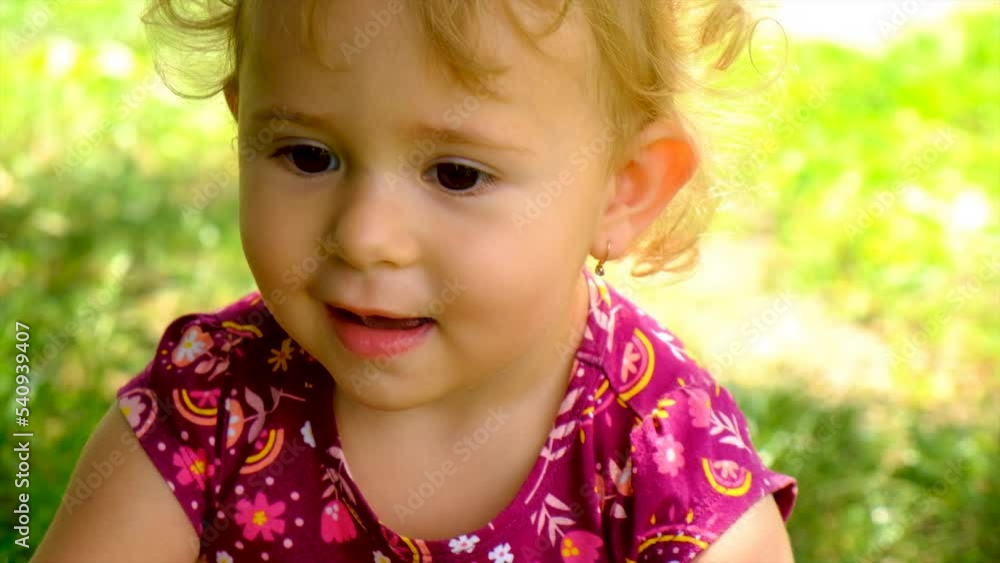 The child laughs in the park. Selective focus. The child laughs in the park. Selective focus.