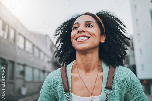 Photography Black woman, city travel and smile with exchange student holding backpack and feel happy looking at buildings and walking down street
