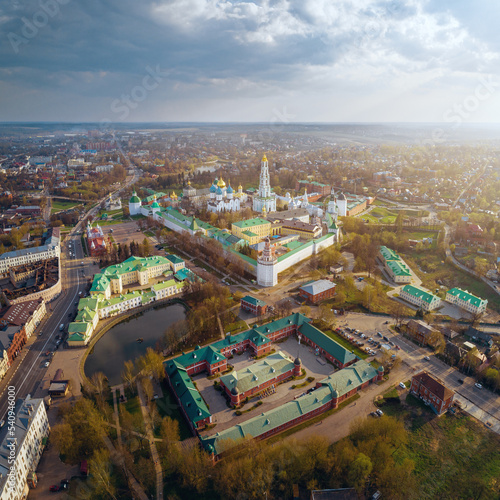Aerial view of Trinity St. Sergy Monastery at autumn sunset with flares. Sergiev Posad, Russia