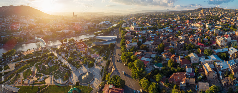 Panoramic aerial view of a summer sunset over downtown Tbilisi, Georgia. Rike Park in the foreground