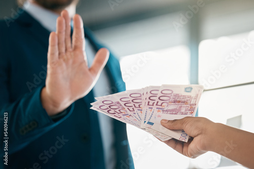 Money, finance and hand of a businessman saying stop fraud, corruption and money laundering in the corporate industry. Euros, bribery and person rejecting a cash or financial payment trade deal photo