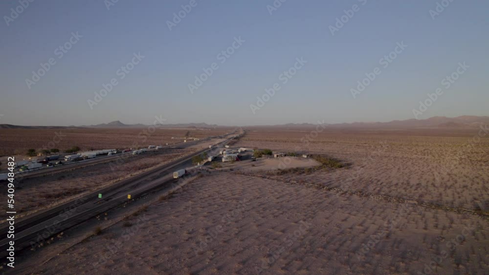 Aerial view of the mountain highway in California. Traffic of interstate in mountain area with driving cars and trucks. Aerial view of the mountain highway in California. Traffic of interstate in mountain area with driving cars and trucks.