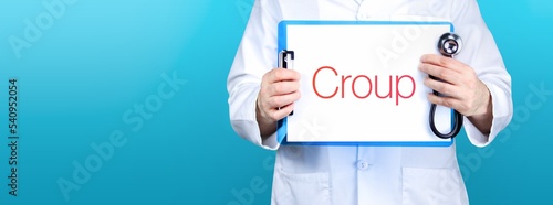 Croup. Doctor holding blue sign with paper. Word is written on document. Stethoscope in hand.