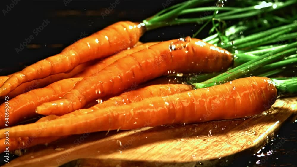 Drops of water fall on carrots. Filmed is slow motion 1000 fps. High quality FullHD footage