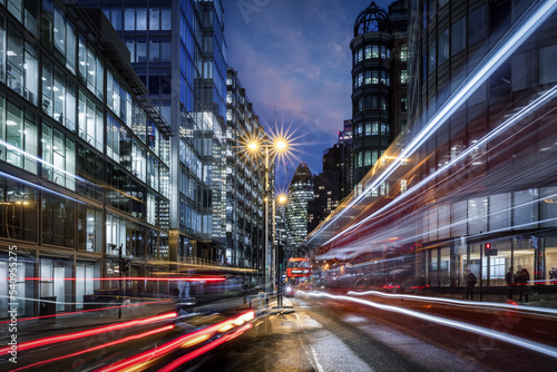 Photographie Evening view of a busy road in the City of London with traffic light trails and