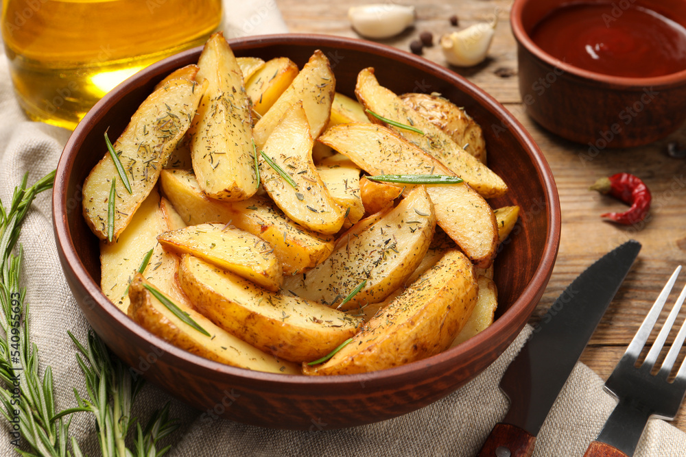 Delicious baked potatoes with spices served on wooden table, closeup Delicious baked potatoes with spices served on wooden table, closeup