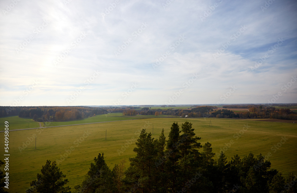 Beautiful autumn landscape with view on a field and forest, selective focus