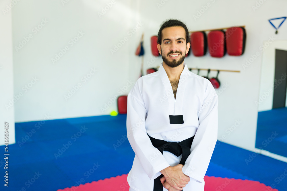 Happy man with a black belt at a karate practice Happy man with a black belt at a karate practice