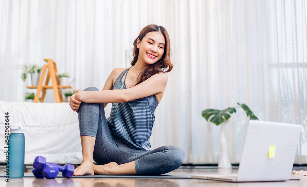 Portrait sport asian beauty body slim woman in sportswear sitting relax and girl practicing yoga and do fitness exercise with laptop computer in bedroom at home.Diet concept.Fitness and healthy Portrait sport asian beauty body slim woman in sportswear sitting relax and girl practicing yoga and do fitness exercise with laptop computer in bedroom at home.Diet concept.Fitness and healthy