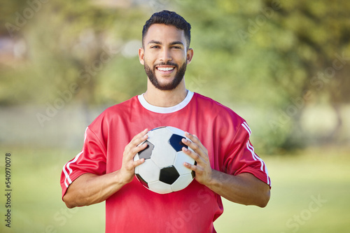 Sports man, soccer player and soccer field training with a soccer ball, happy and relax before fitness workout. Football, football player and sport portrait of excited player ready for game