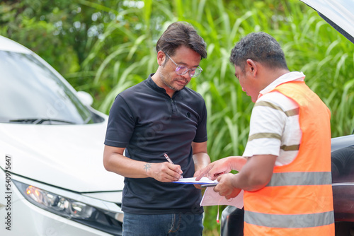 Car insurance agent talks to his client about claiming a car repair service.