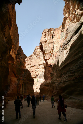 Petra, Jordan, November 2019 - A group of people walking in front of a mountain