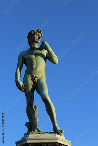 Bronze Statue  copy of Michelangelo s David  with a clear blue sky on the background  in Piazzale Michelangelo in Florence  Tuscany  Italy. Vertical with coipy space on the right.