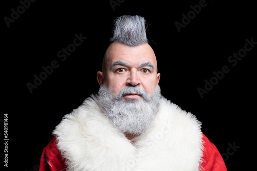 Severe dangerous Santa Claus with mohawk. Evil aggressive gray-haired old man Santa in a bad mood. New Year and Christmas in the company of an unusual bad Santa