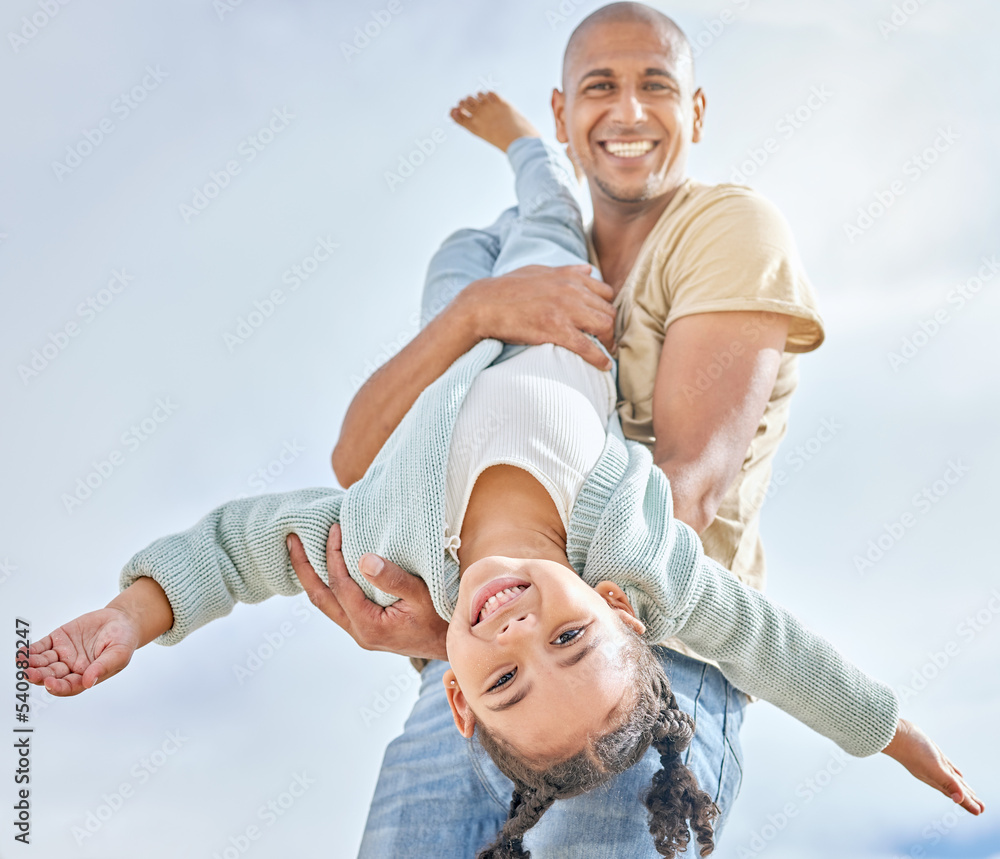 Fototapeta premium Happy, summer with father and girl playing together with love, care and happiness. Upside down child with a happy smile with dad spending quality time outdoor having kid fun in the sun on vacation