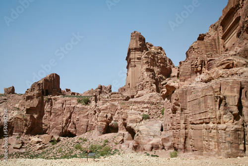 Petra, Jordan, November 2019 - A person standing in front of a large rock