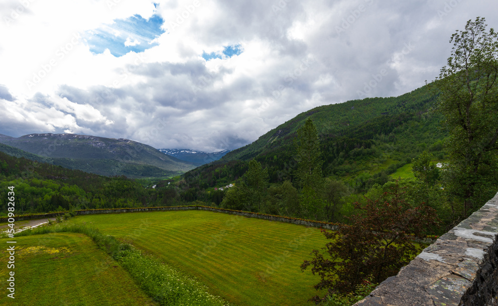 Beautiful Lush Green Summer Mountain View Of The Naeroy Valley With Overcast Sky At Stalheim Hotel In Vossestrand, Western Norway.