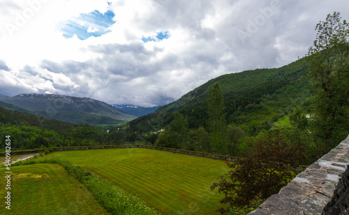 Beautiful Lush Green Summer Mountain View Of The Naeroy Valley With Overcast Sky At Stalheim Hotel In Vossestrand  Western Norway.