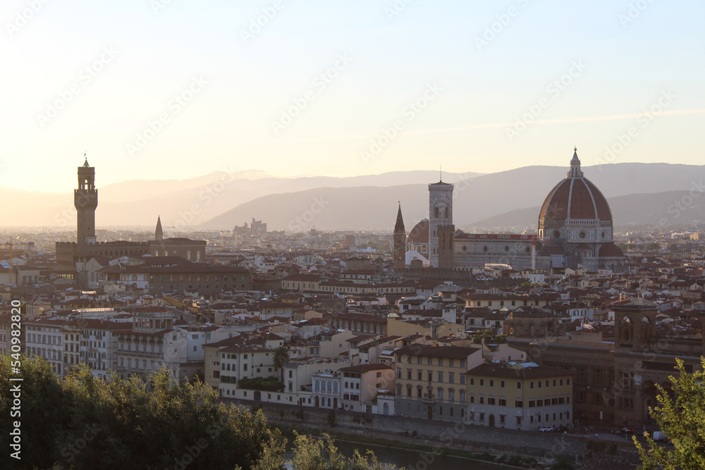 Panoramic view over Florence from Piazzale Michelangelo at sunset, with Palazzo Vecchio on the left and Brunelleschi's Dome on the right. Horizontal 