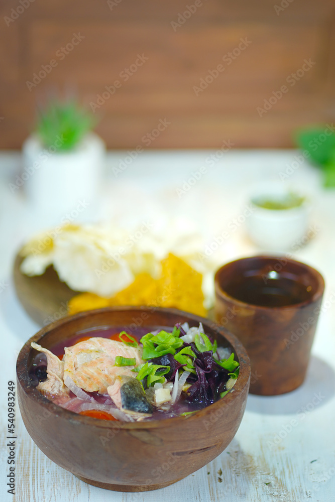 Salmon soup with purple spinach in the wooden bowl Salmon soup with purple spinach in the wooden bowl